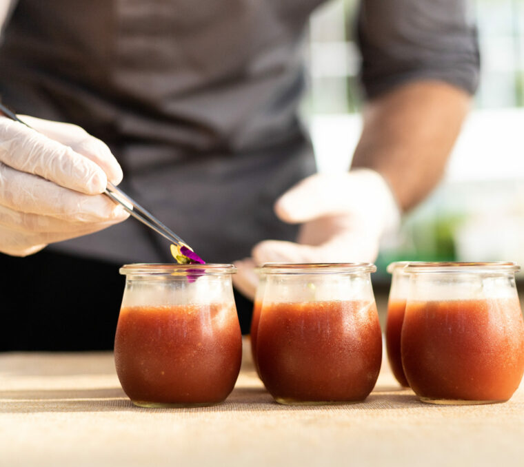 Chef placing garnish on food